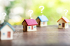 Réussir investissement immobilier – maisons miniatures avec points d’interrogation